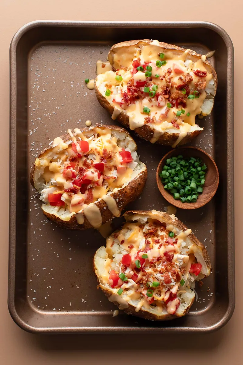 Loaded Chicken Baked Potatoes with cheddar and shredded cheese