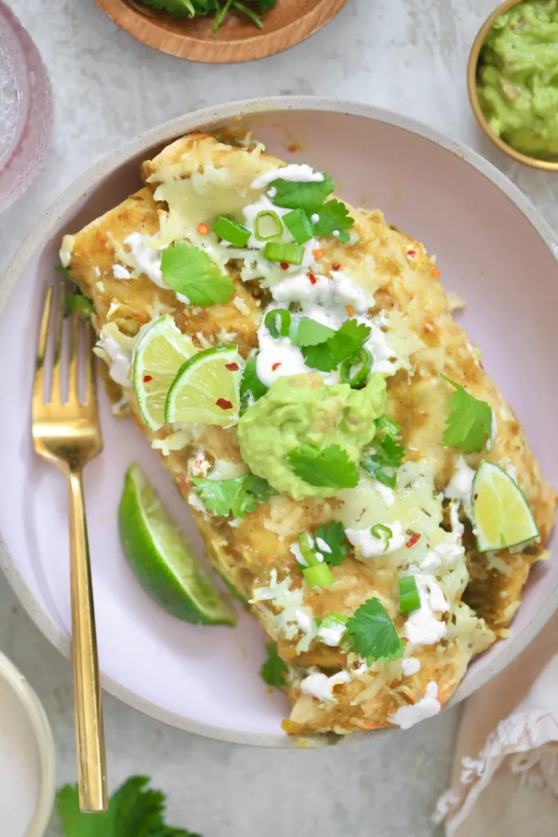 Green Chicken Enchiladas with cheddar and shredded cheese